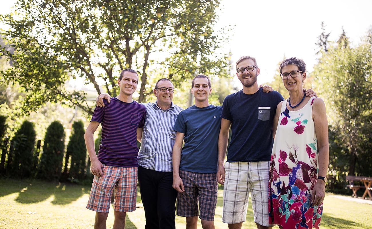 The family Leiter that runs the Hotel Lindenhof sitting on a lawn