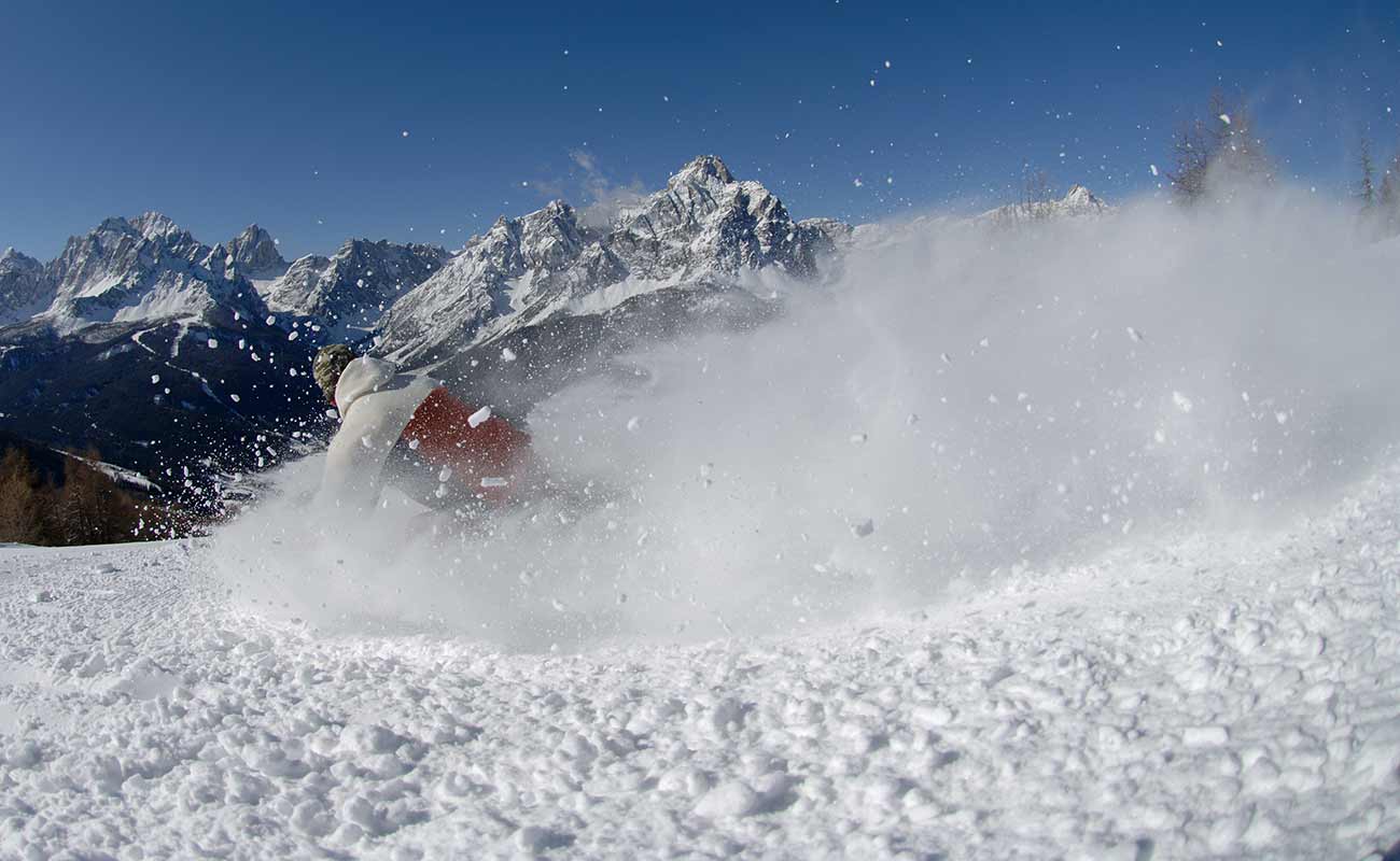 A person skis on fresh snow